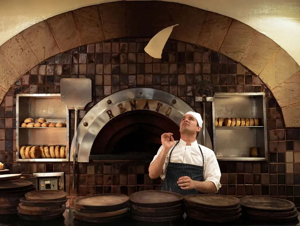 Carlo, our pizzaiolo, preparing a pizza in the kitchen at Bella Italia